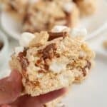 Hand holding a s'mores rice krispies treat.