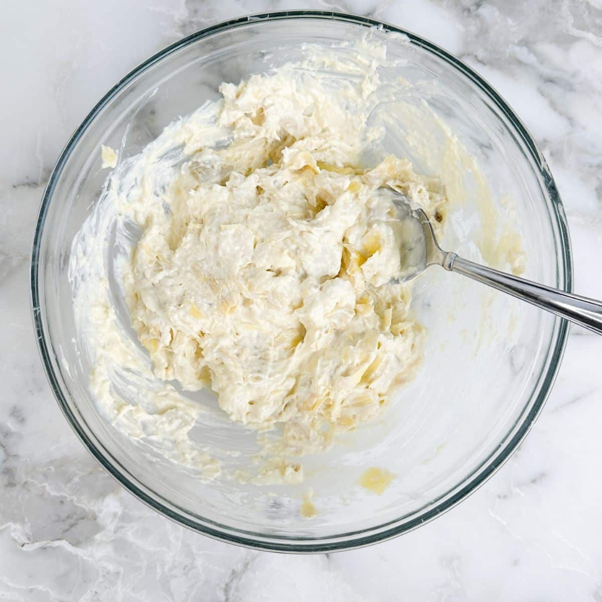 Bowl of artichoke dip mixture.