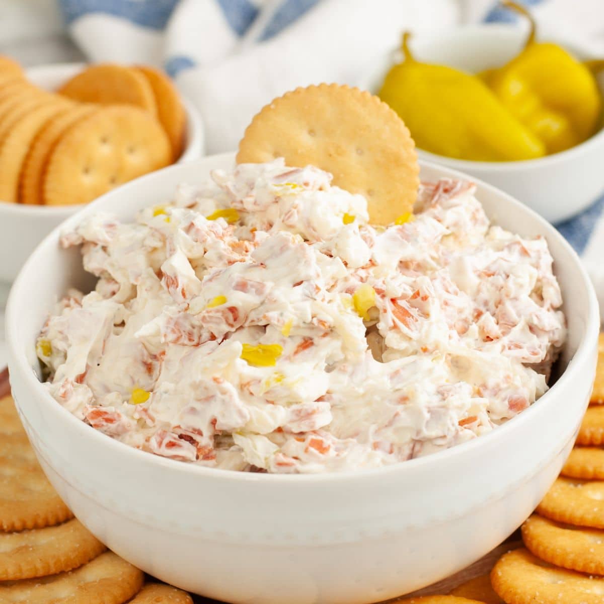 Bowl of pepperoni dip with Ritz crackers. 