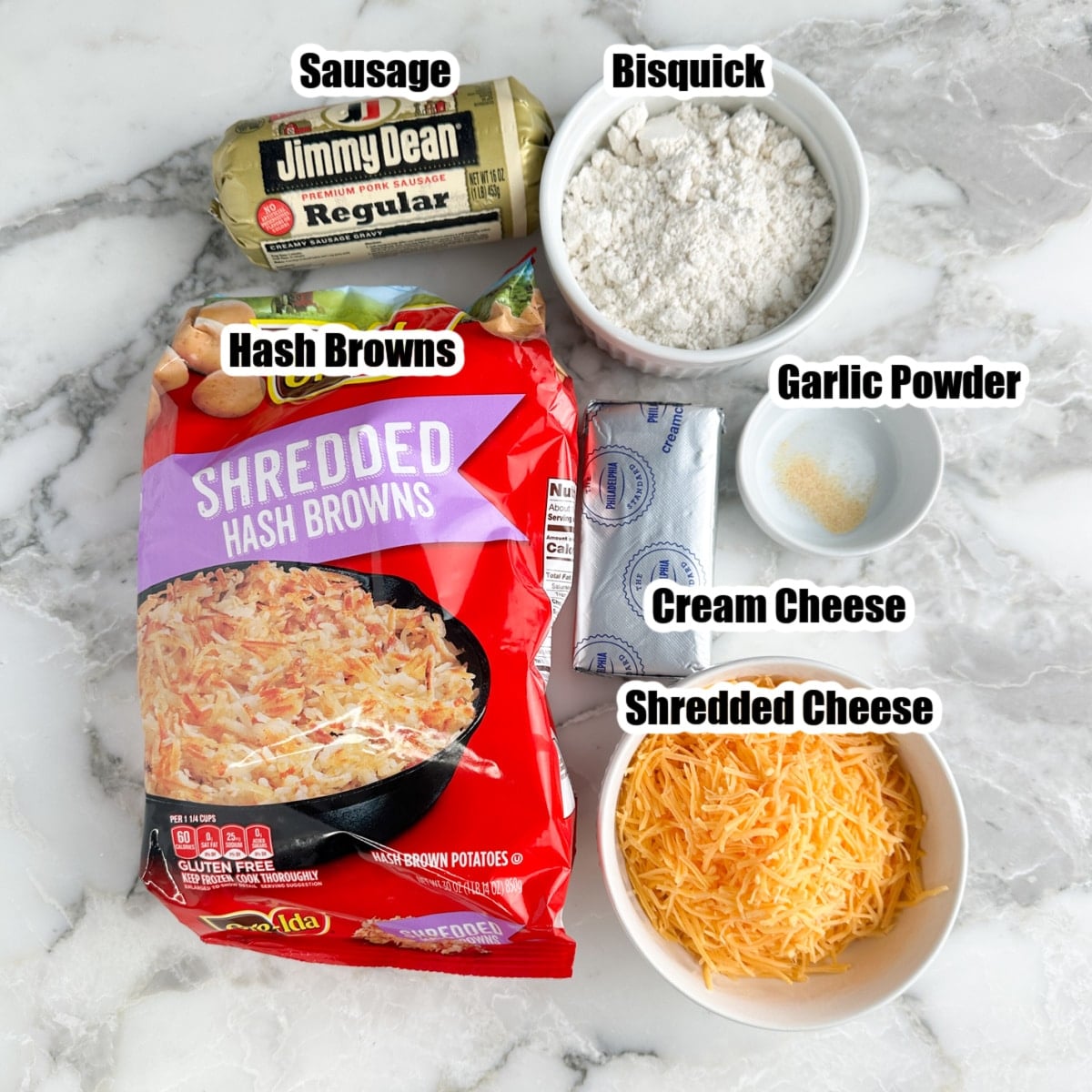 Bag of hash browns, sausage, shredded cheese, cream cheese, garlic powder, and bowl of Bisquick.