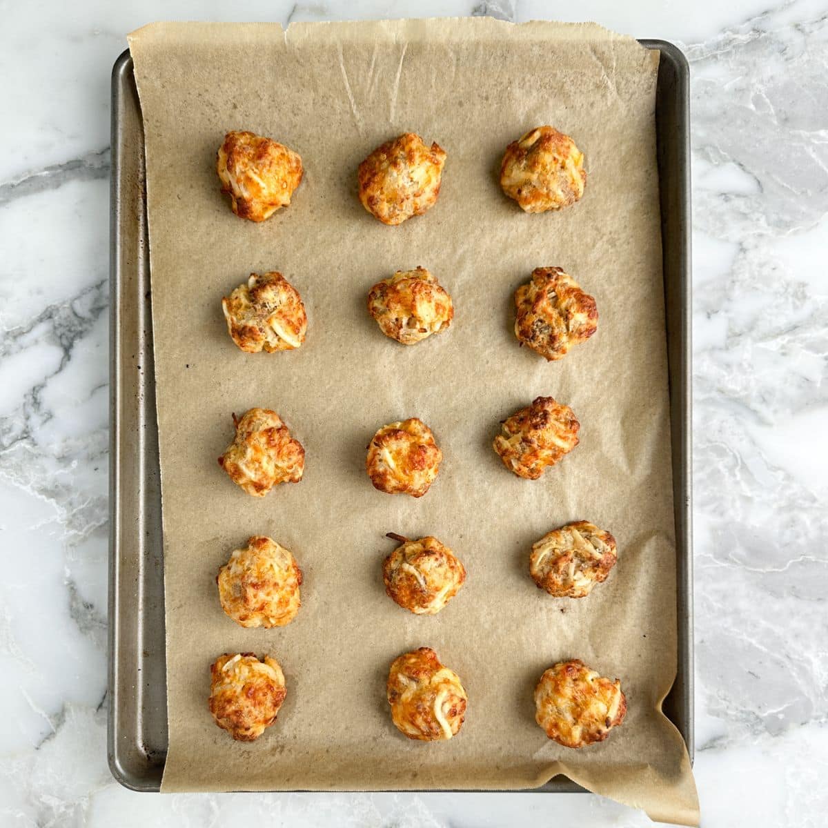 Baked hash brown bites on a baking dish.