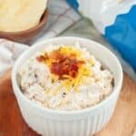 Bowl of loaded baked potato dip and potato chips.
