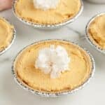 Mini pumpkin cream pies topped with whipped cream.