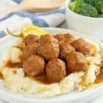 Plate of meatballs over mashed potatoes.