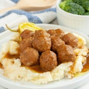 Plate of meatballs over mashed potatoes.