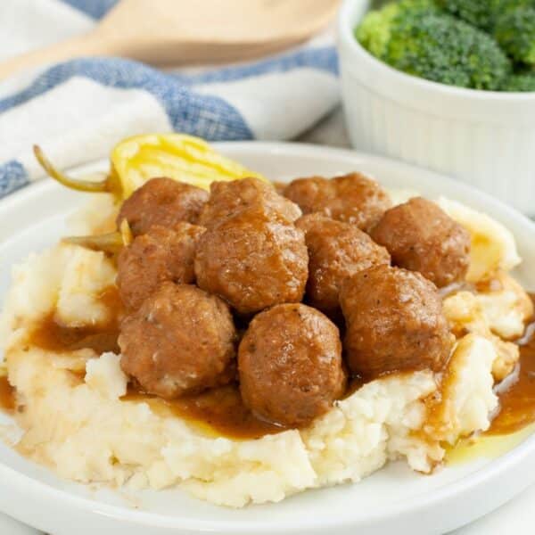 Plate of meatballs over mashed potatoes.