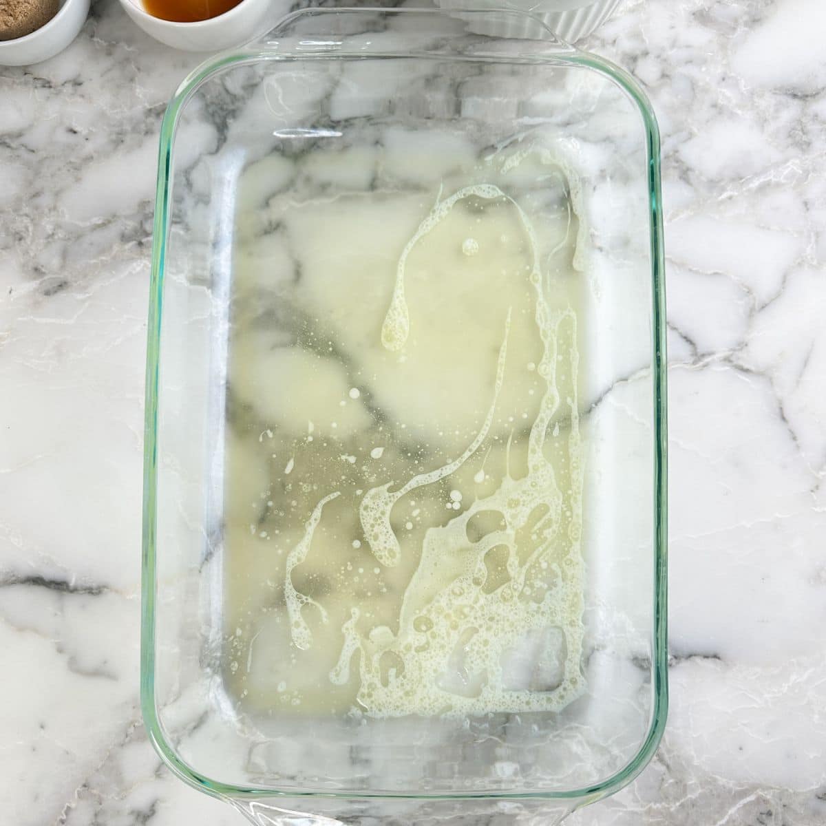 Baking dish with melted butter.