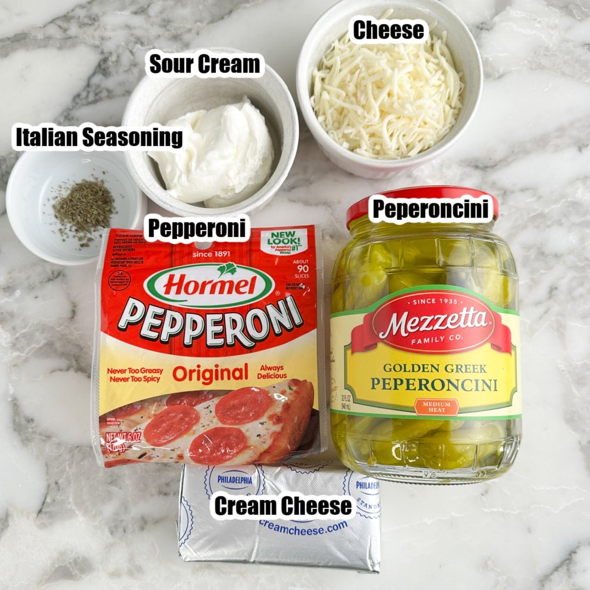 Bag of pepperonis, cream cheese, jar of peperoncini peppers, sour cream, mozzarella, and Italian seasoning. 