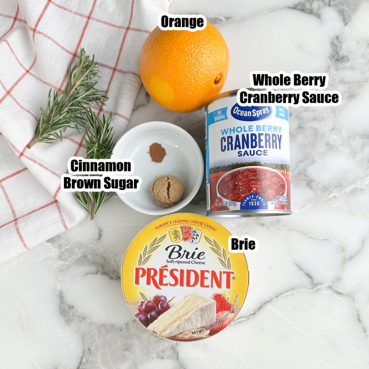 Orange, can of cranberry sauce, brie cheese, cinnamon, and brown sugar.