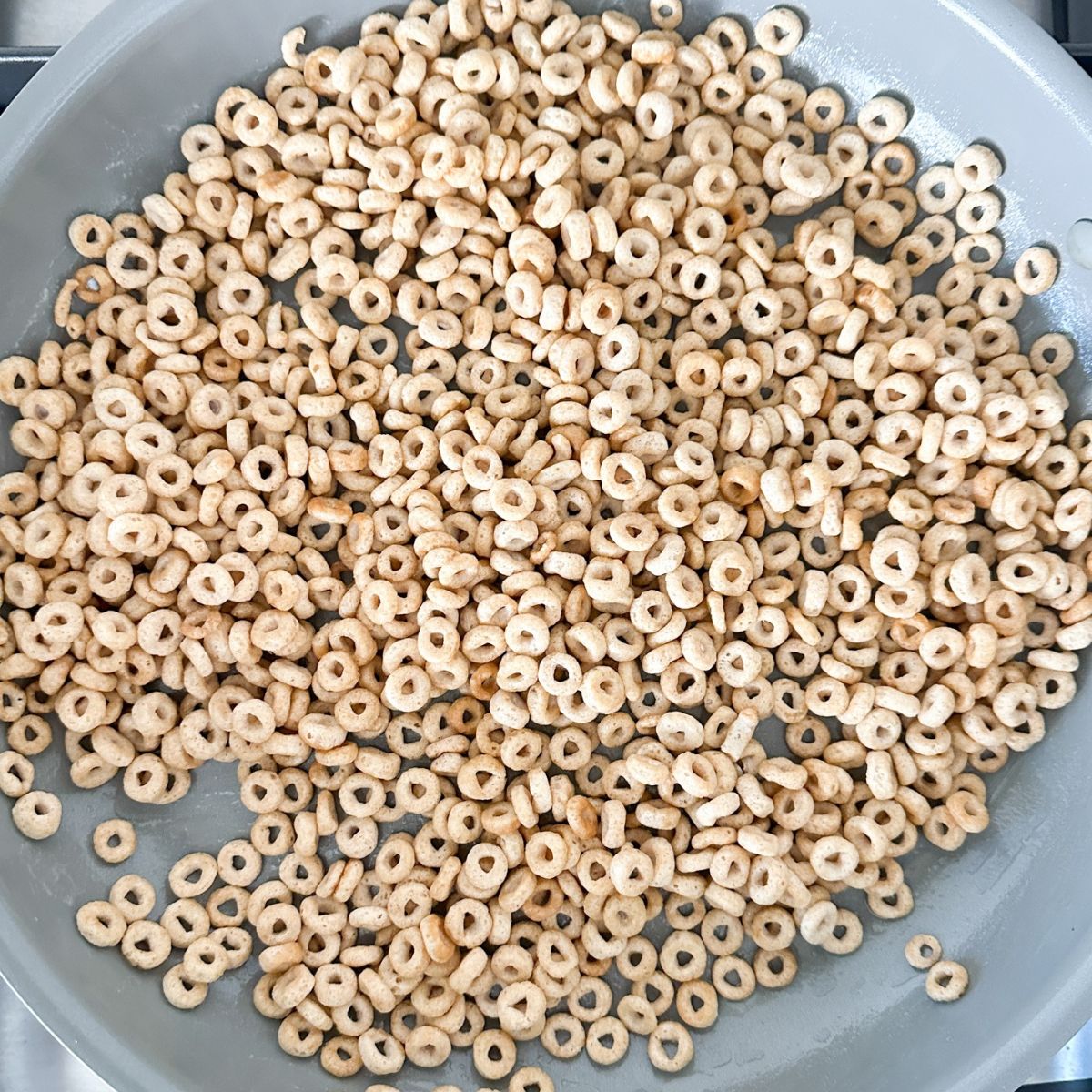 Skillet with buttered Cheerios. 