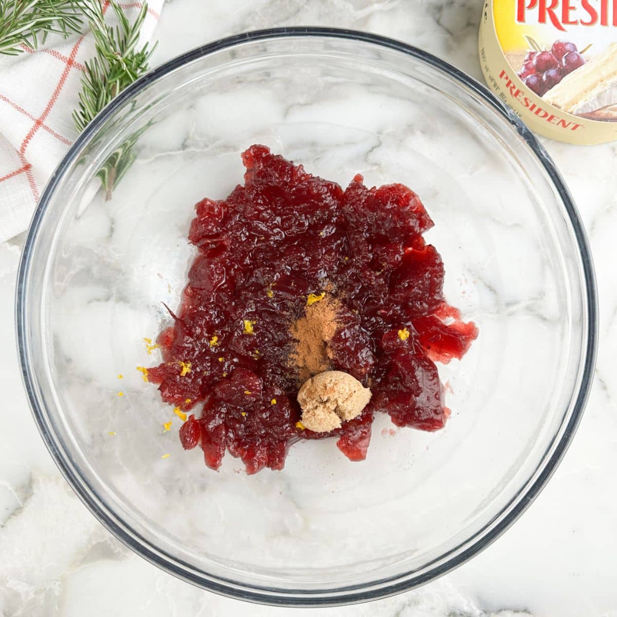 Bowl of cranberry sauce, brown sugar, and cinnamon.