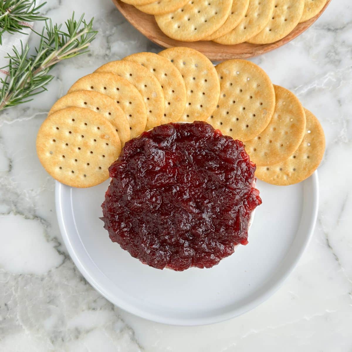 Plate with cranberry brie and crackers.