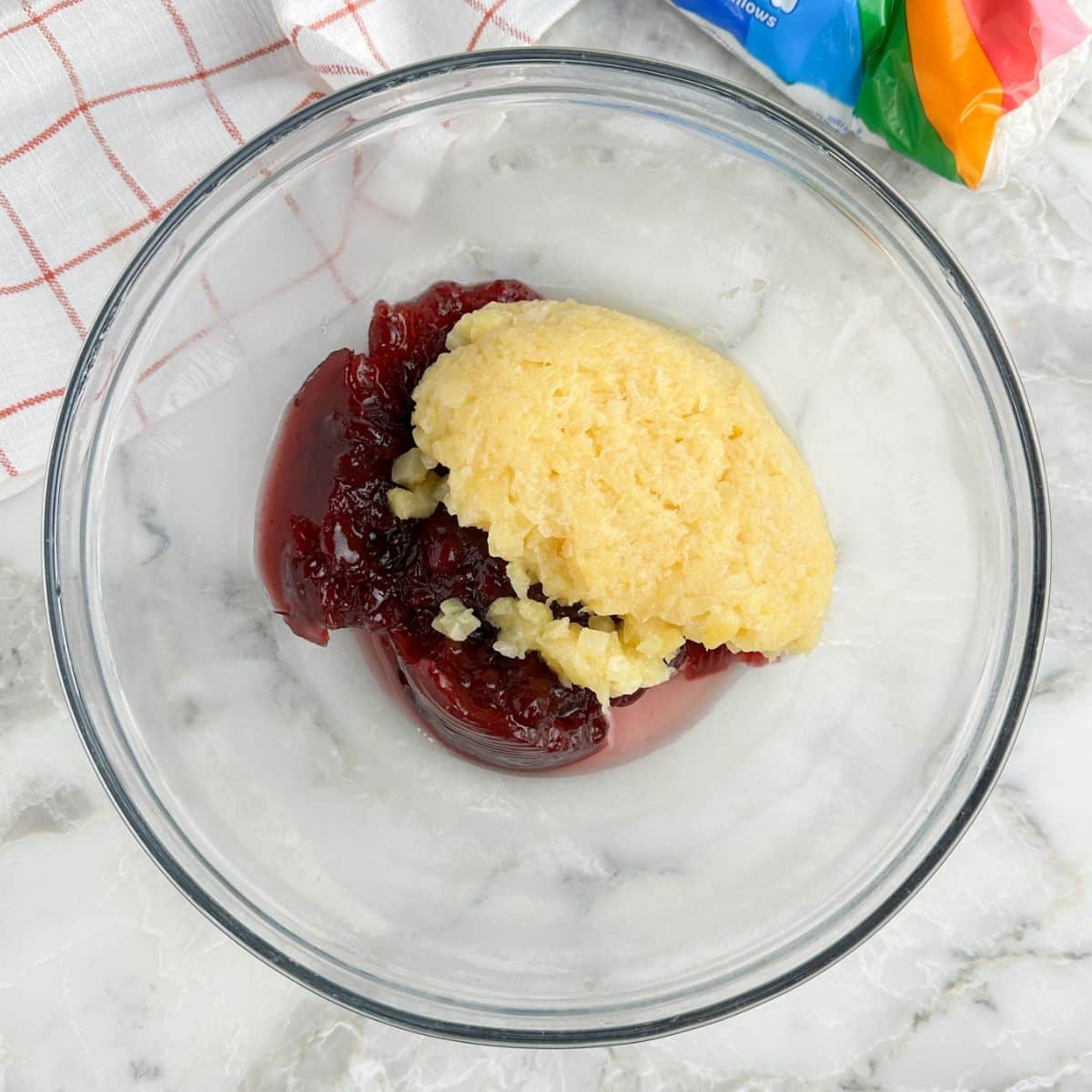 Bowl with cranberry jelly and crushed pineapple.