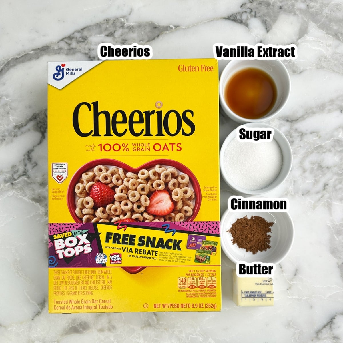 Box of Cheerios, bowl of vanilla, sugar, cinnamon, and butter.
