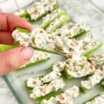 Hand holding stuffed celery.