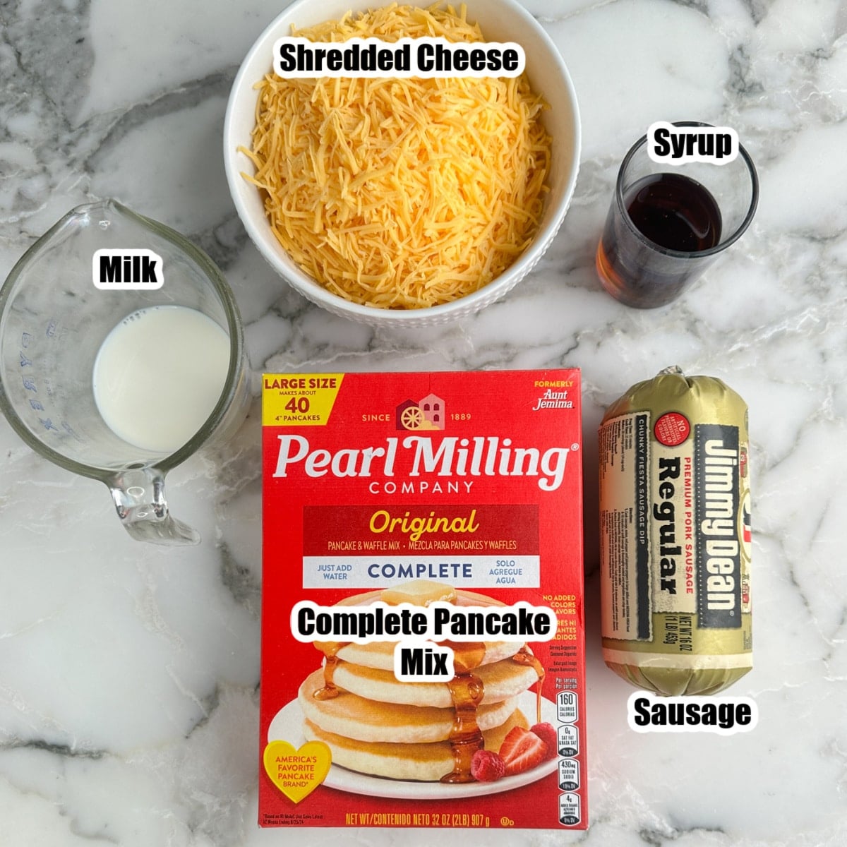 Box of pancake mix, shredded cheese, sausage, syrup, and milk.