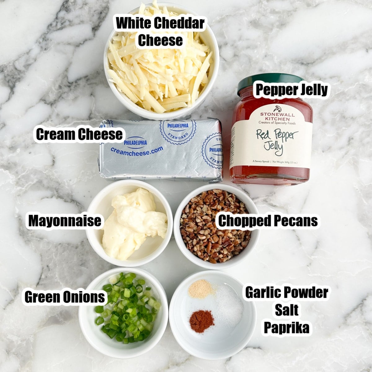 Bowl of white cheddar cheese, mayonnaise, green onions, chopped pecans, seasonings, cream cheese, and jar of pepper jelly.