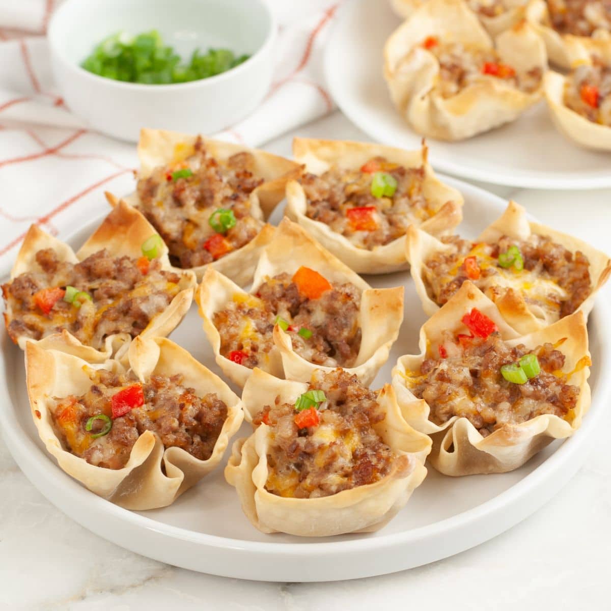 Plate of cheesy sausage wonton cups.
